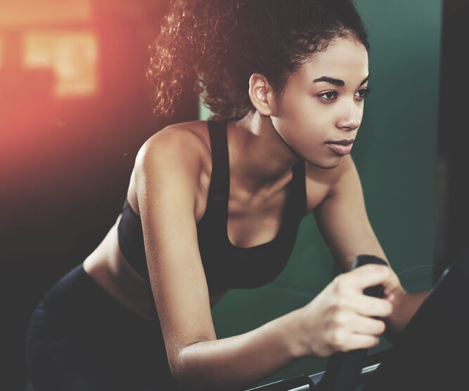 Young woman on a spin bike