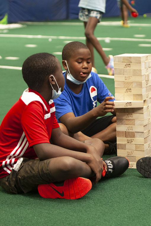 Boys sitting and playing Jenga